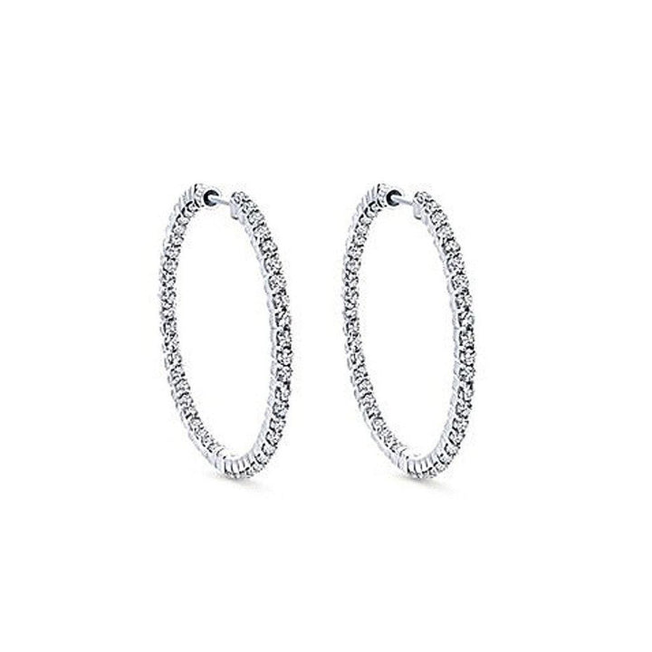 One-inch diamond hoop earrings, sparkling on white background.