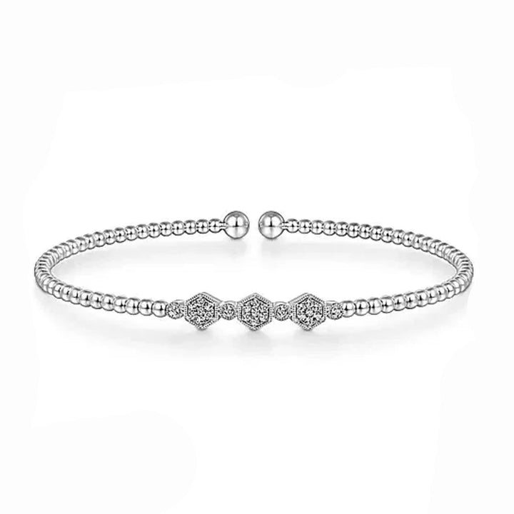 Elegant white gold bangle bracelet featuring a beaded design and three hexagon diamond accents.