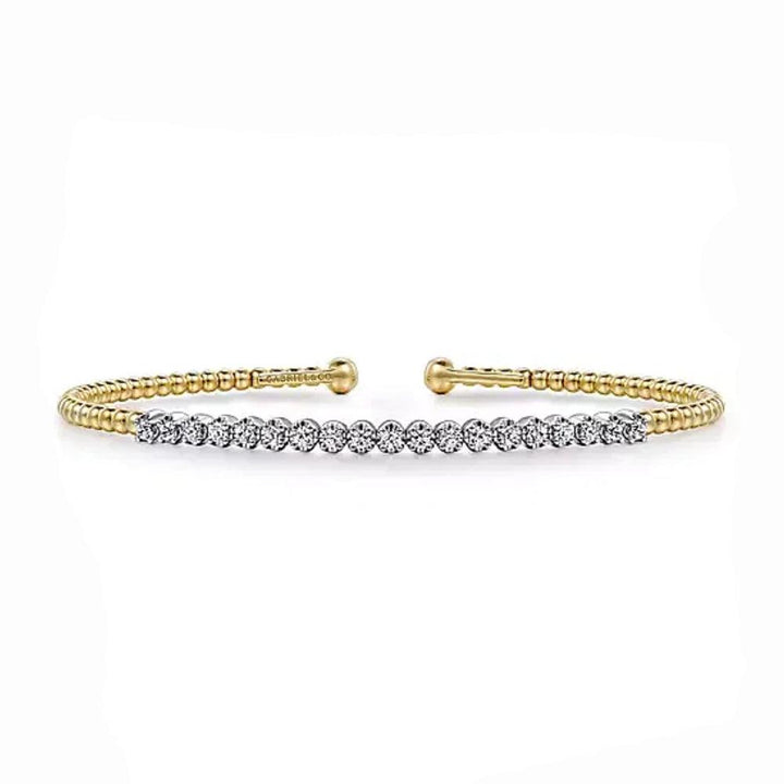Diamond cuff bracelet in white and yellow gold, featuring beaded detailing.