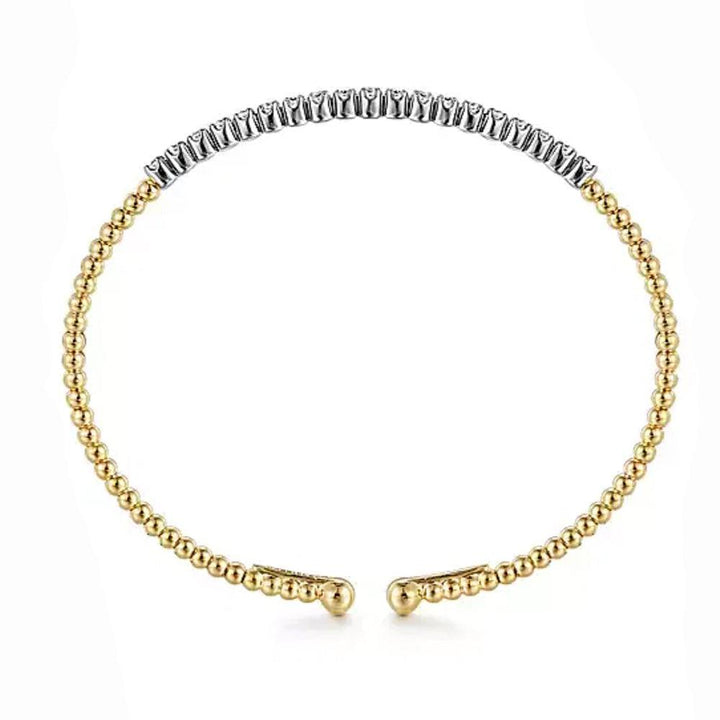 Beaded cuff bracelet in 14K gold with a diamond accent.