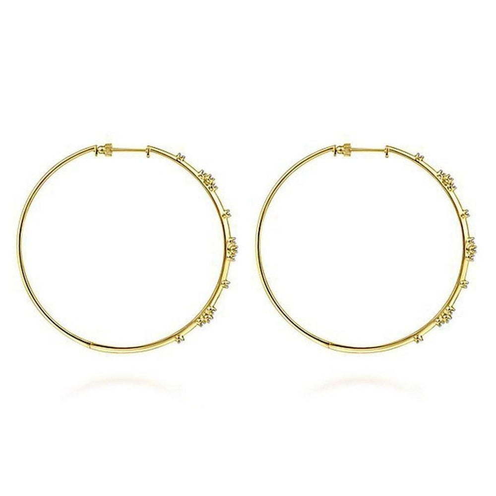 Large 14K yellow gold hoop earrings adorned with tiny diamonds.