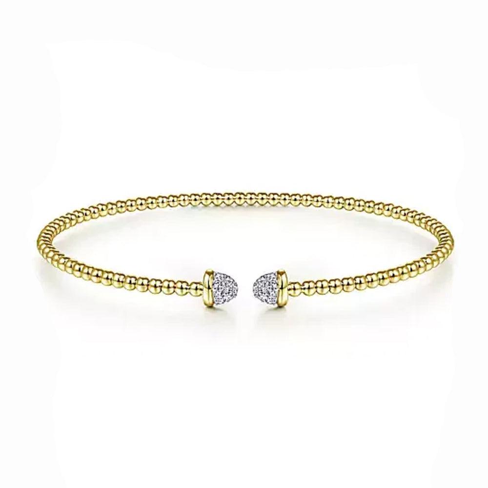 Beaded gold bangle bracelet with pave diamond accents.