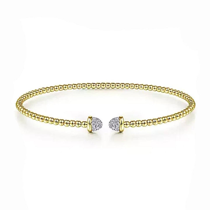 Beaded gold bangle bracelet with pave diamond accents.