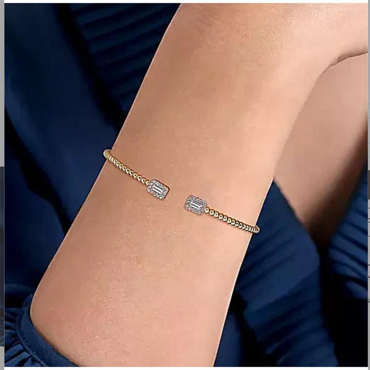 14K gold beaded cuff bracelet adorned with emerald-cut diamond accents.