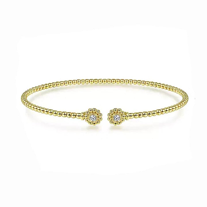 Beaded gold cuff bracelet with sparkling diamond accents.