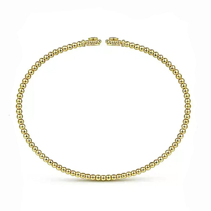 14K yellow gold beaded bangle bracelet featuring diamond flower accents.