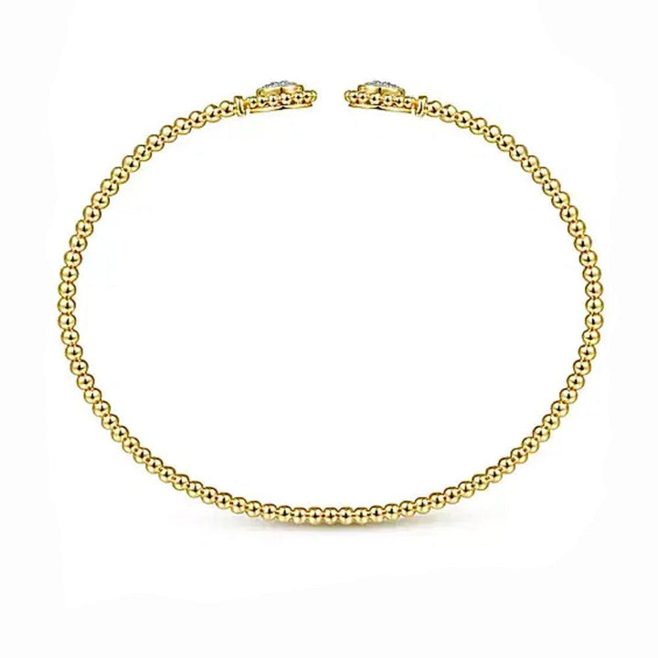 14K gold beaded bangle bracelet adorned with pave diamond accents.