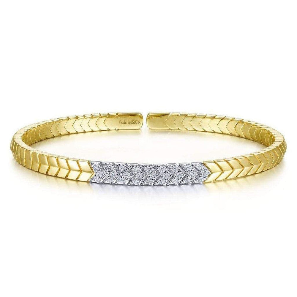 Chevron cuff bracelet in 14k gold with diamond accents.