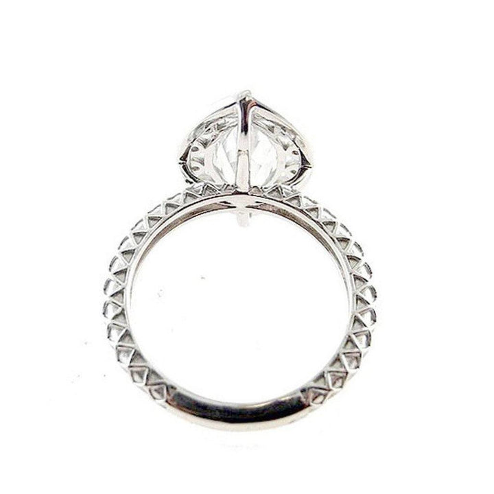White gold marquise diamond ring, showcasing a detailed textured band.