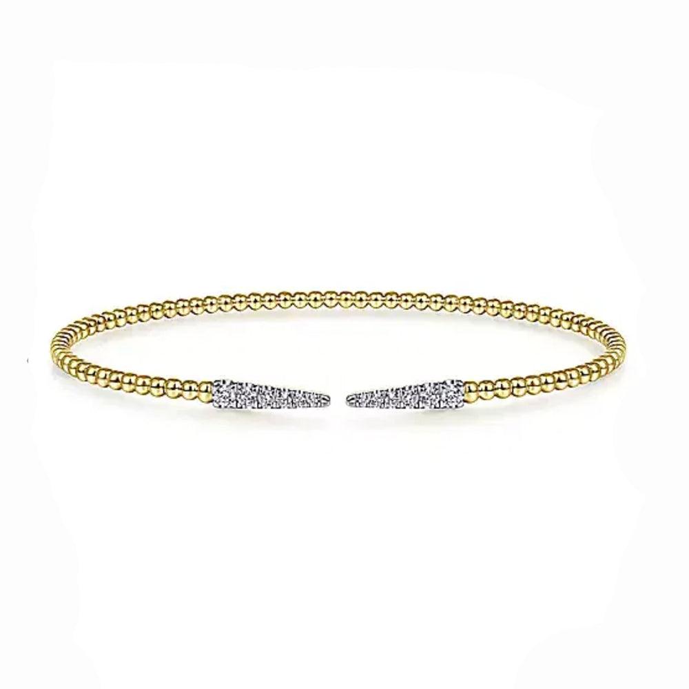 Beaded gold cuff bracelet accented with diamond pave spike details.