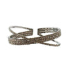 Silver 4-row crystal cuff bracelet with crisscross design.