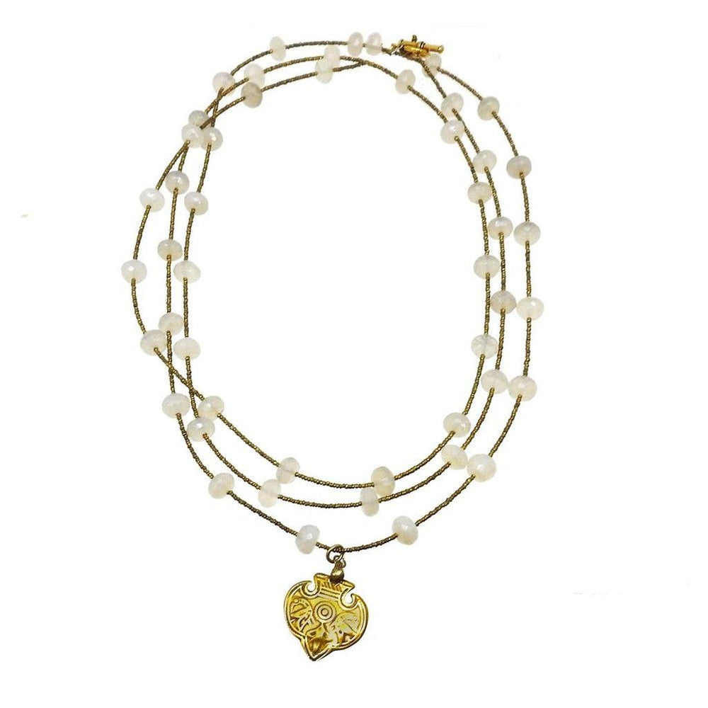 Triple-strand necklace featuring off-white gemstone beads and a gold pendant.
