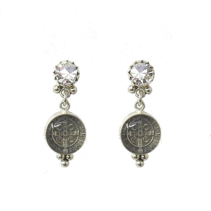 Silver earrings featuring a clear crystal and a St. Benedict medal charm.