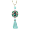 Amethyst & Turquoise Tassel Necklace: Gold chain, large emerald green gemstone, purple & green accents, turquoise tassel.