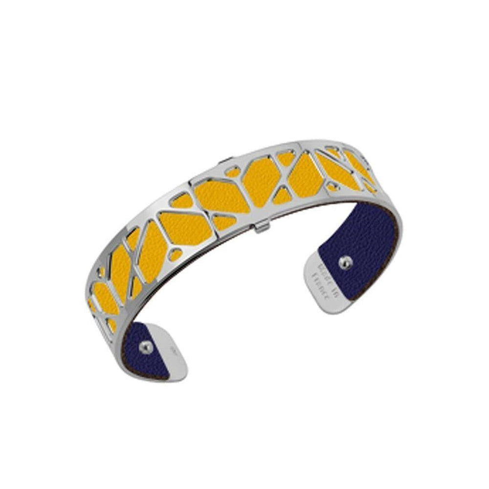 Silver cuff bracelet with yellow leather inlay and navy blue leather backing.