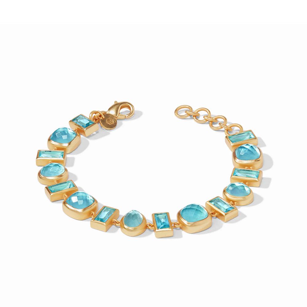 Gold bracelet featuring a mosaic of light blue gemstones in various shapes.