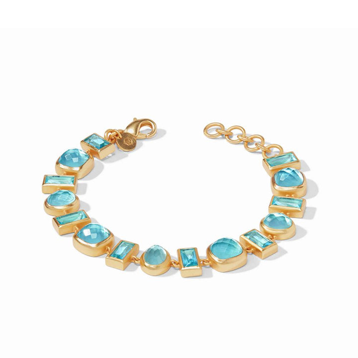 Gold bracelet featuring a mosaic of light blue gemstones in various shapes.