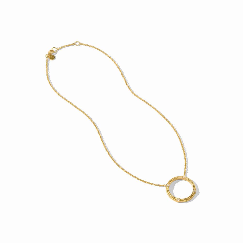 Gold necklace with textured circular pendant and small diamonds.