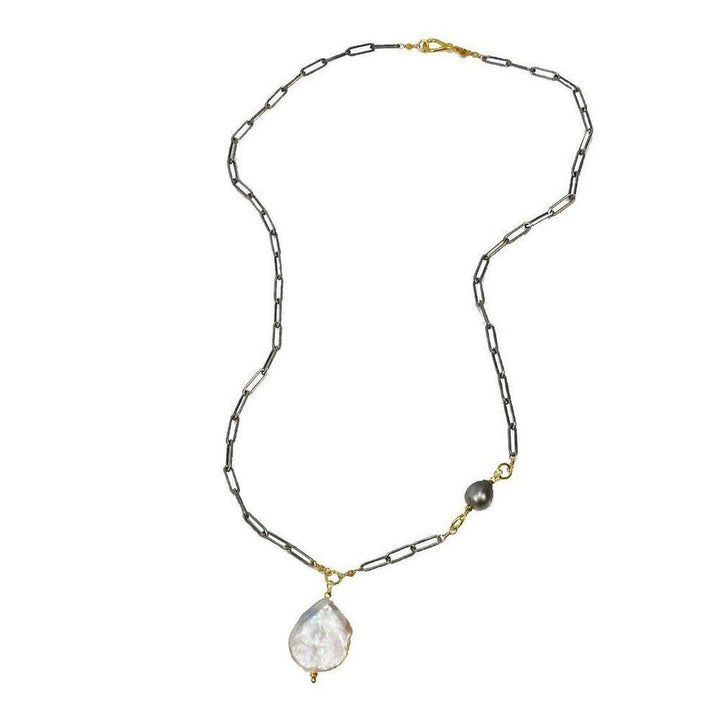 Elegant baroque pearl necklace with dark metal chain and smaller pearl accent.