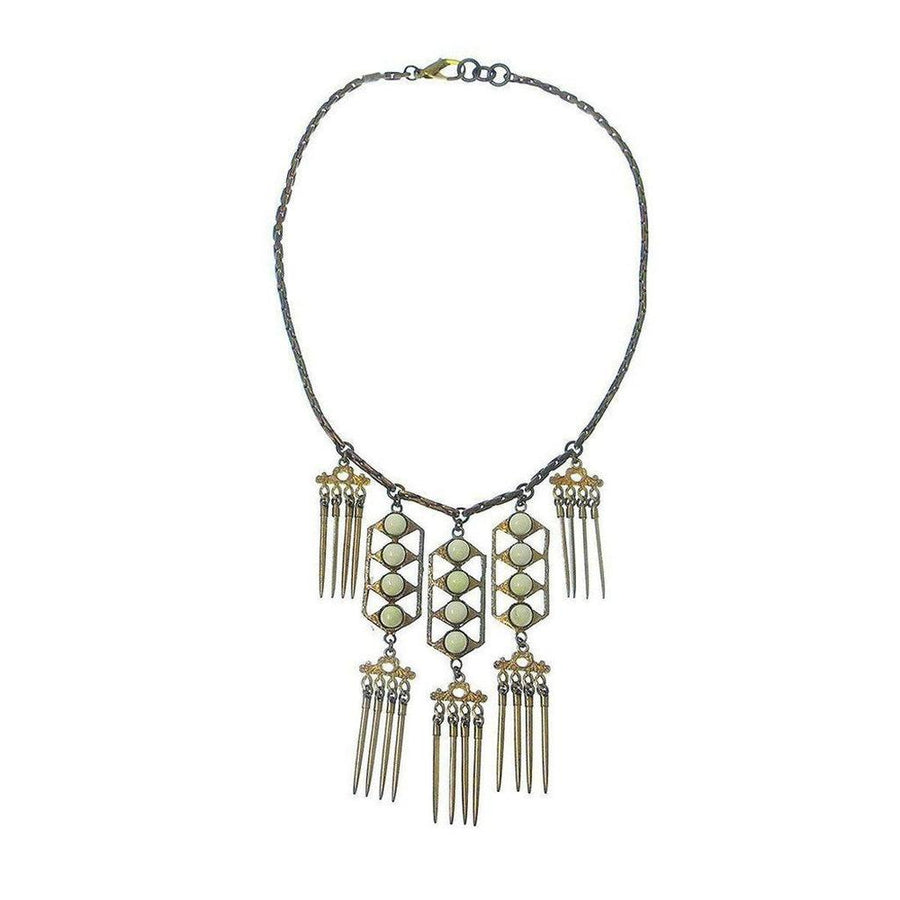 Beachcomber necklace: gold & bronze chain, off-white stones, geometric pendant with fringe accents.