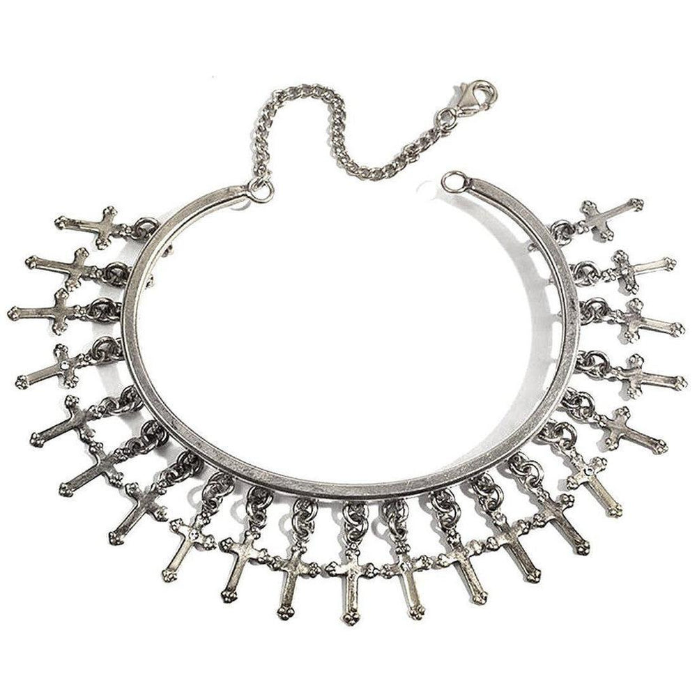 Silver cuff bracelet adorned with dangling cross charms.