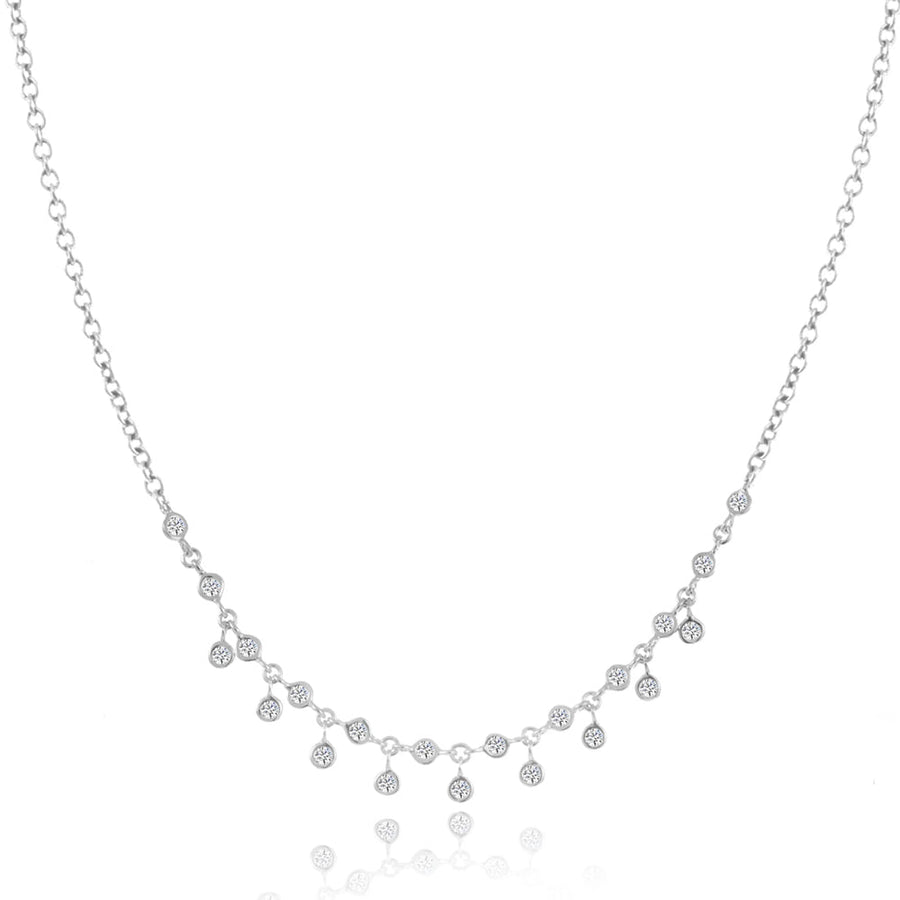 Elegant bezel diamond necklace with delicate dangling accents.
