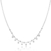 Elegant bezel diamond necklace with delicate dangling accents.