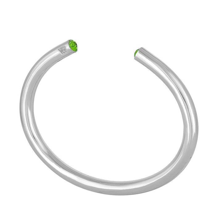 Silver cuff bracelet featuring a vibrant green gemstone.