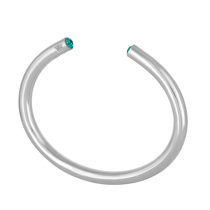 Silver bangle bracelet adorned with teal gemstones.