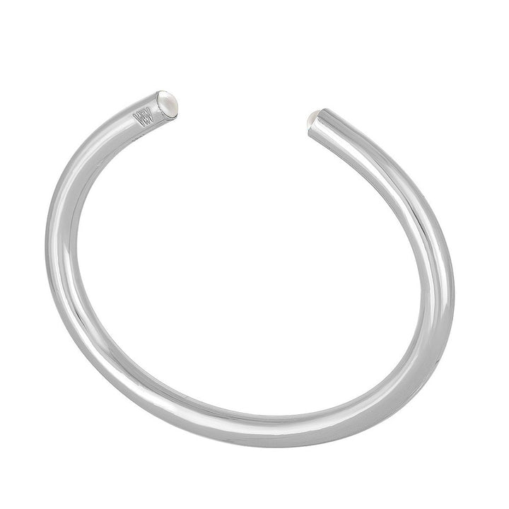 Silver bangle bracelet featuring subtle pearl accents.