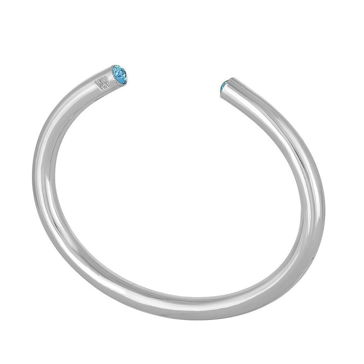 Silver cuff bracelet featuring a light blue gemstone.