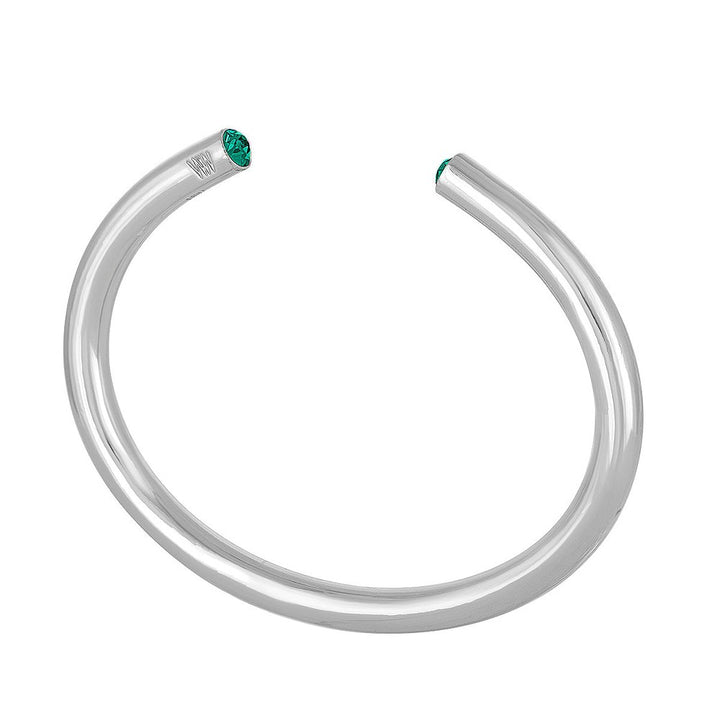 Silver cuff bracelet featuring a vibrant green gemstone.