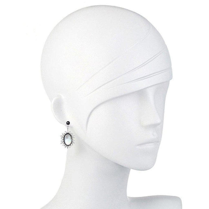 Elegant oval earrings; mother-of-pearl and onyx accents.