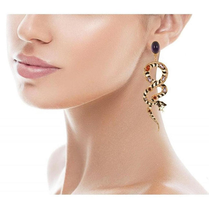 Gold snake earrings with black and white enamel, adorned with colorful gemstones.