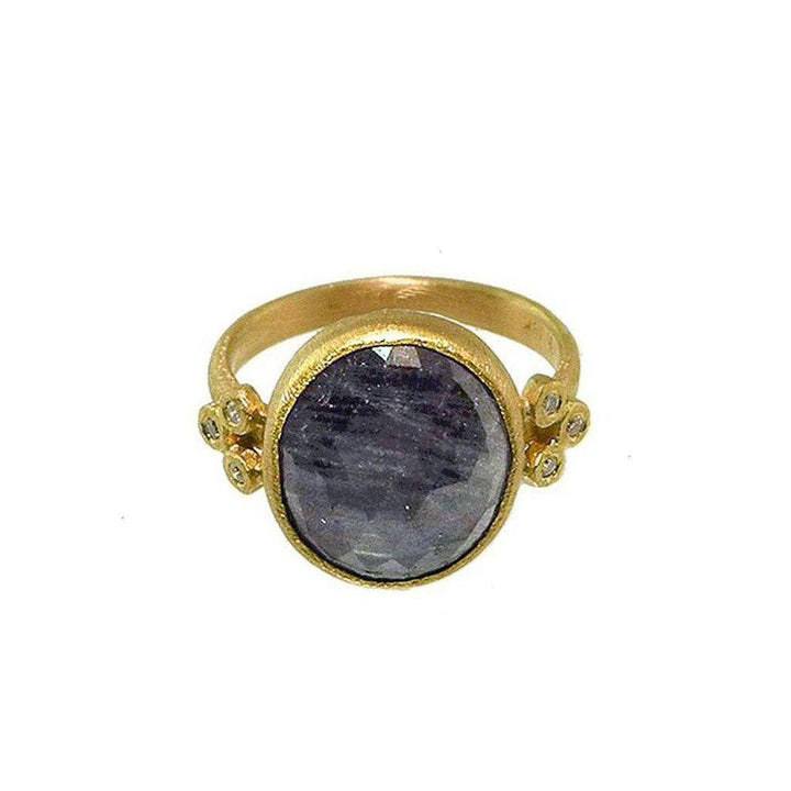 Oval blue sapphire gemstone ring in 18k gold with accent diamonds.