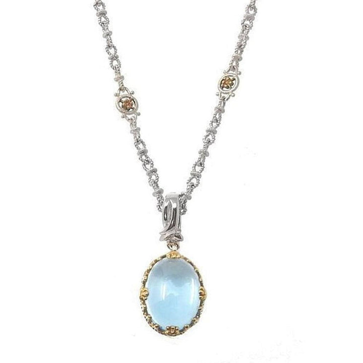 Elegant blue topaz pendant necklace with silver chain and gold accents.