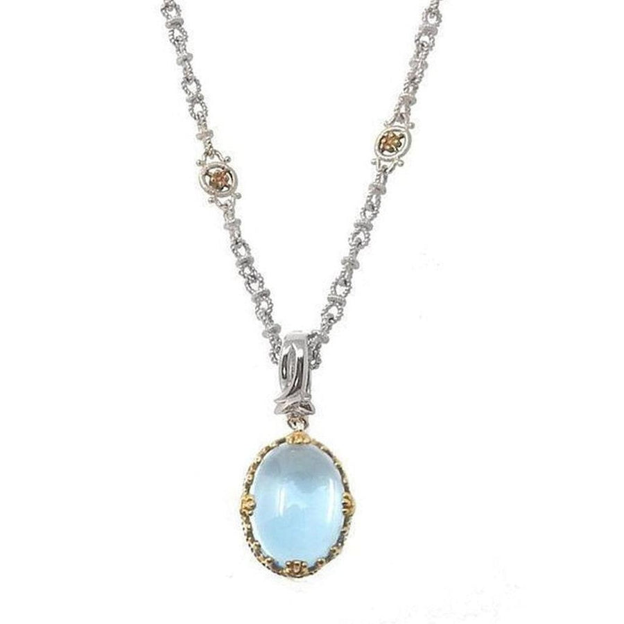 Elegant blue topaz pendant necklace with silver chain and gold accents.