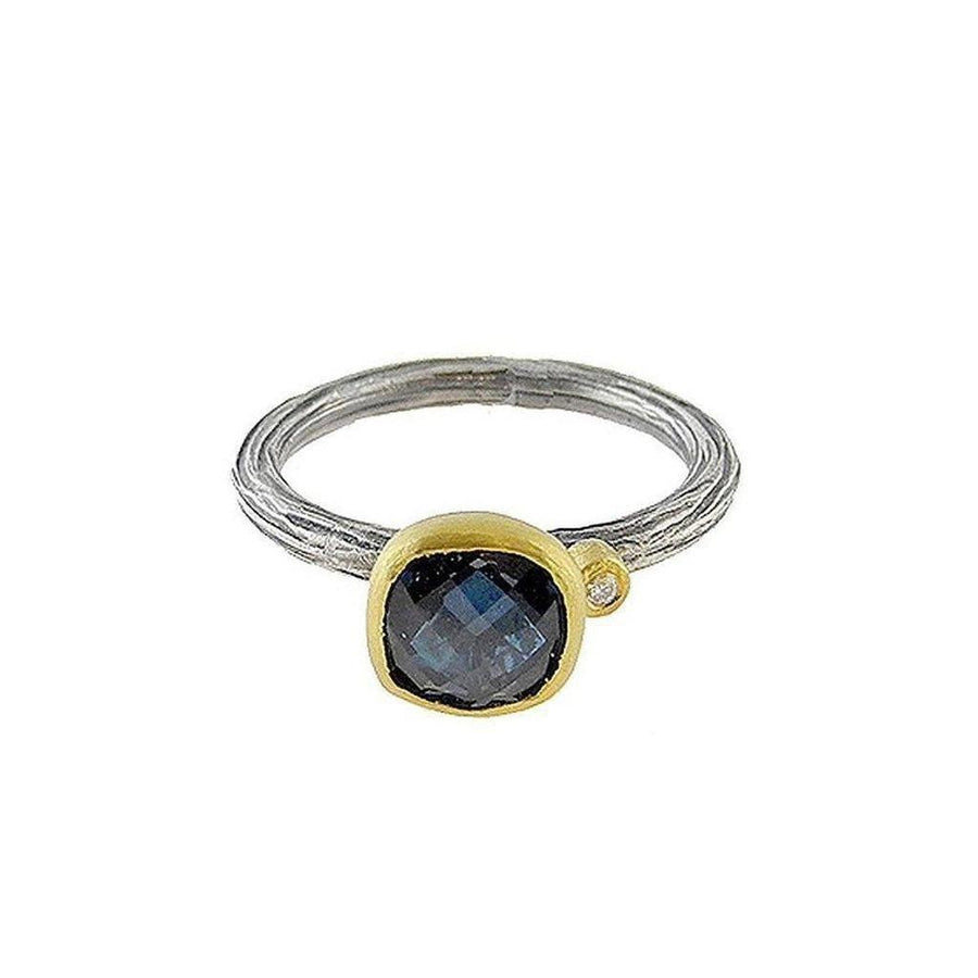 Textured silver & gold ring featuring a cushion-cut blue topaz.