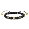 Black obsidian and gold skull beaded bracelet with adjustable cord.