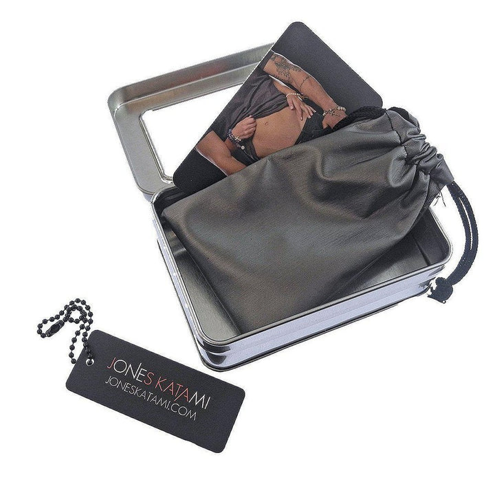 Vintage medallion bracelet in a metallic tin gift box with drawstring pouch.