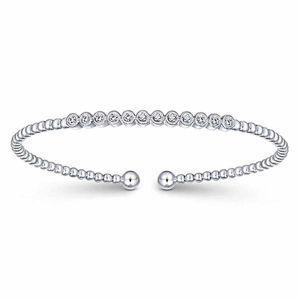 Beaded cuff bracelet featuring twelve bezel-set diamonds.