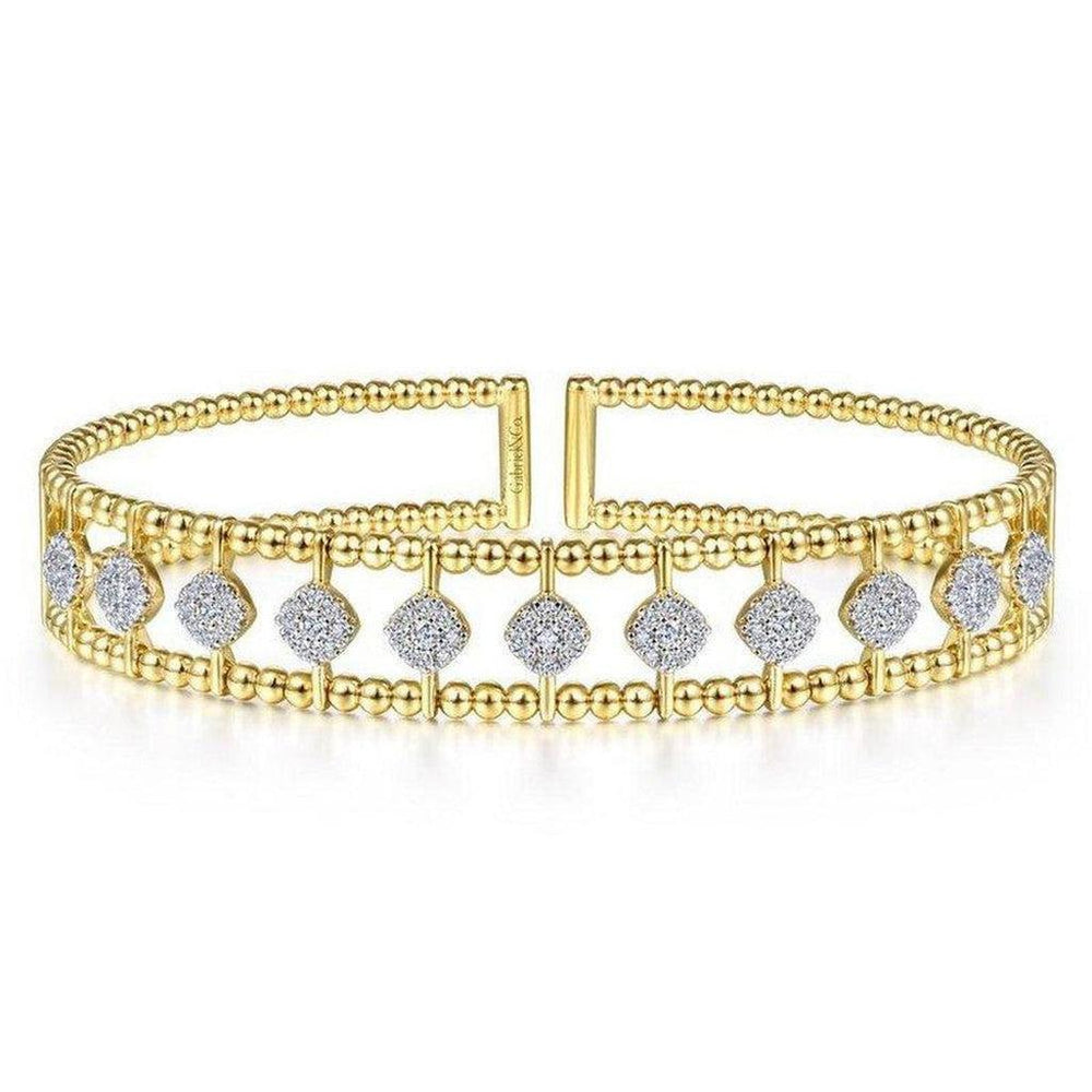 Gold cuff bracelet featuring beaded detailing and sparkling diamond accents.