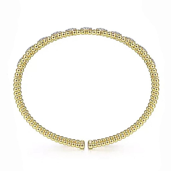 Gold beaded cuff bracelet adorned with small diamonds.