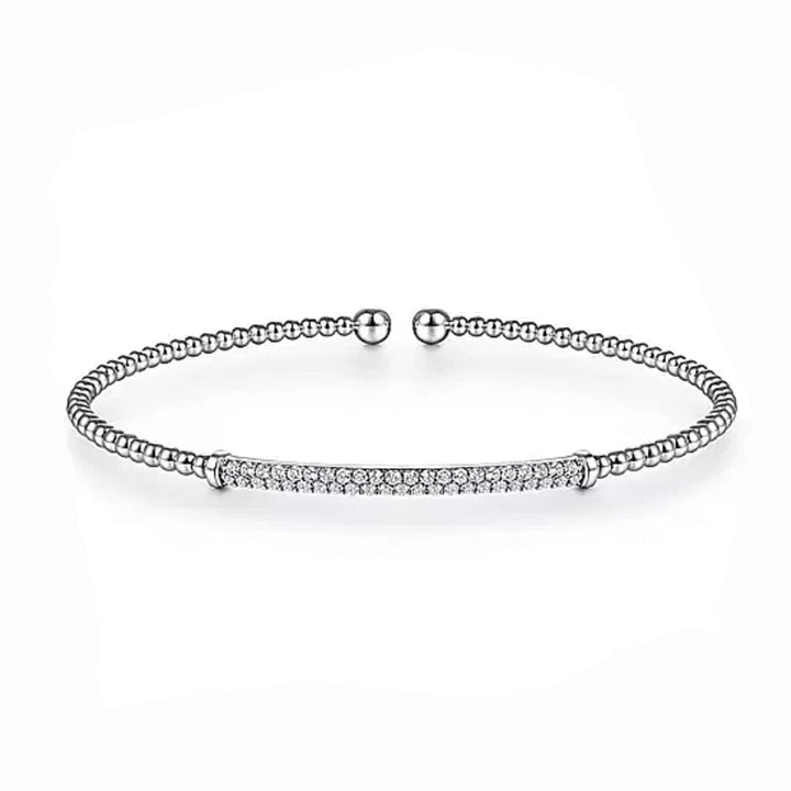 Elegant white gold beaded bangle featuring a pave diamond bar.