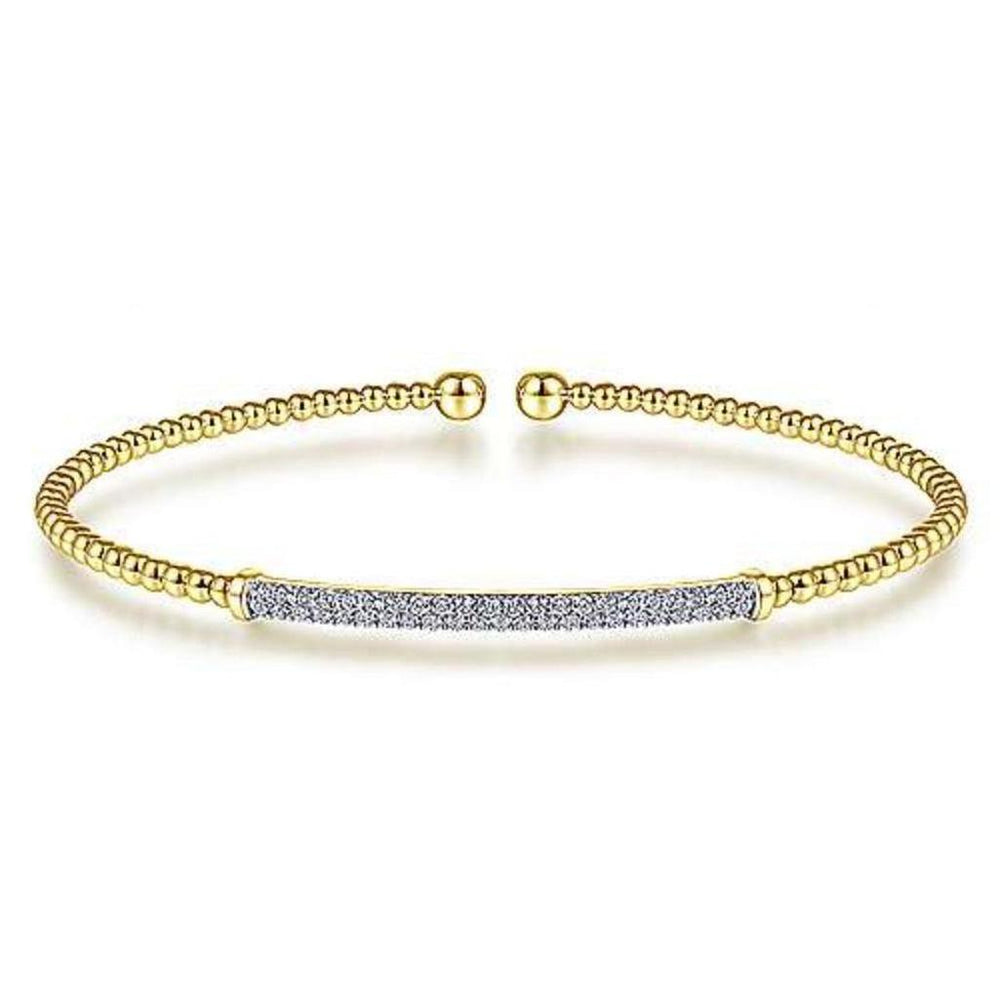 Yellow gold beaded cuff bracelet featuring a pave diamond bar.
