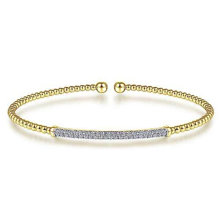 Yellow gold beaded cuff bracelet featuring a pave diamond bar.