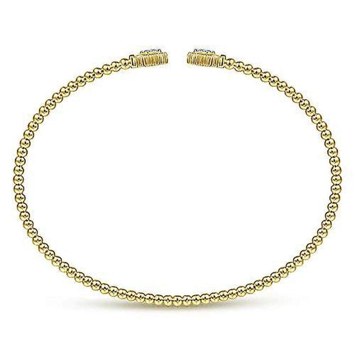 Gold beaded bangle bracelet with small hexagon accents.