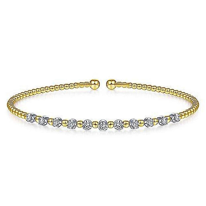Gold beaded cuff bracelet accented with sparkling diamond stations.