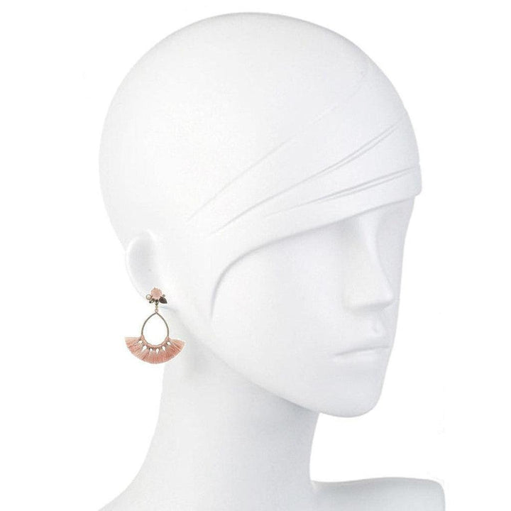 Pink chalcedony and labradorite tassel earrings on a mannequin.