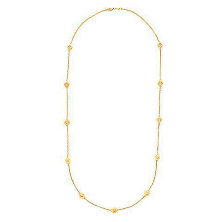 Gold station necklace featuring delicate chain and shimmering accents.
